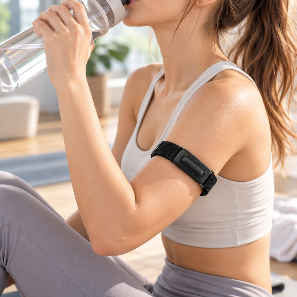 Black Fitbit Air nylon armband worn on the upper arm; device not included
